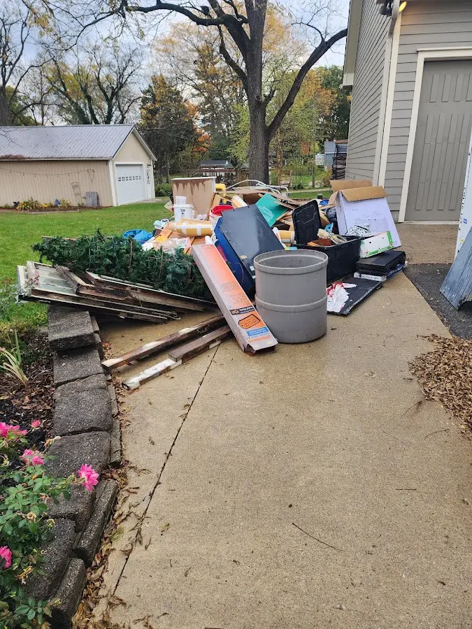 Dumpster being loaded with debris for Roofing Dumpster Rental in Oakland